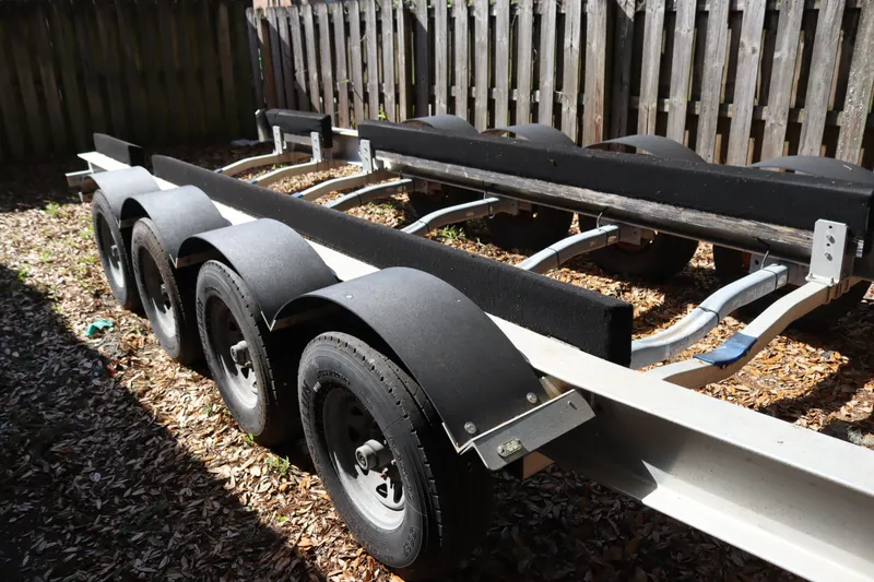 Slide: The Image of Trailer for 2009 Hydra-Sports 4100 VSF boat, parked on leaf-covered ground. - 74