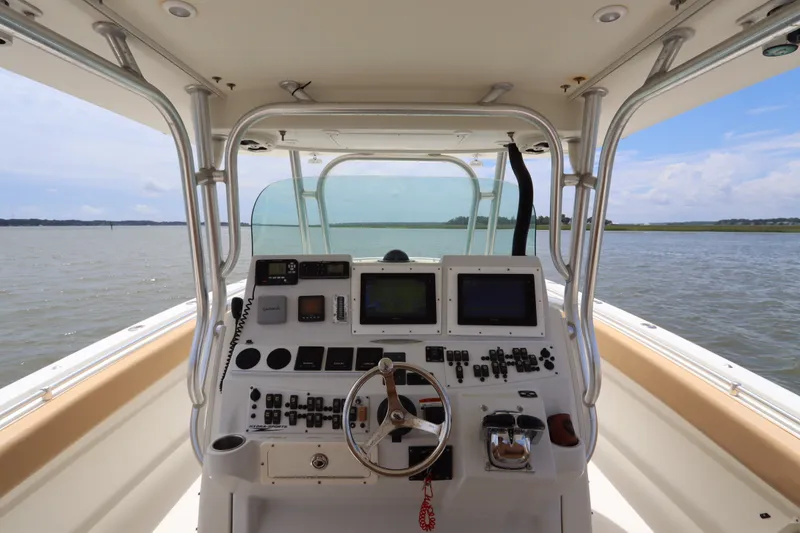Slide: The Image of 2009 Hydra-Sports 4100 VSF boat cockpit with steering wheel and navigation controls on open water. - 36