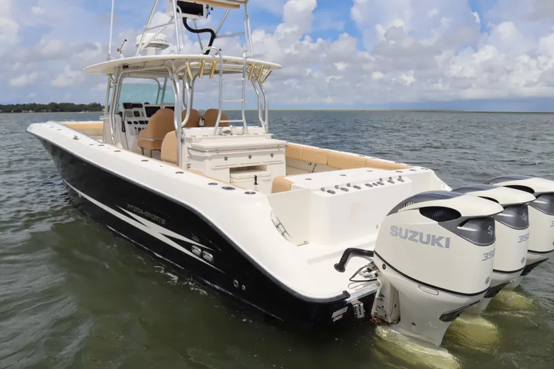 Slide: The Image of 2009 Hydra-Sports 4100 VSF boat with Suzuki engines on open water. - 4