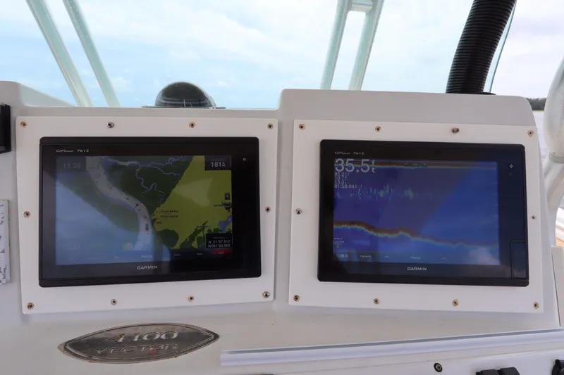 Slide: The Image of Garmin navigation displays on 2009 Hydra-Sports 4100 VSF boat dashboard. - 40