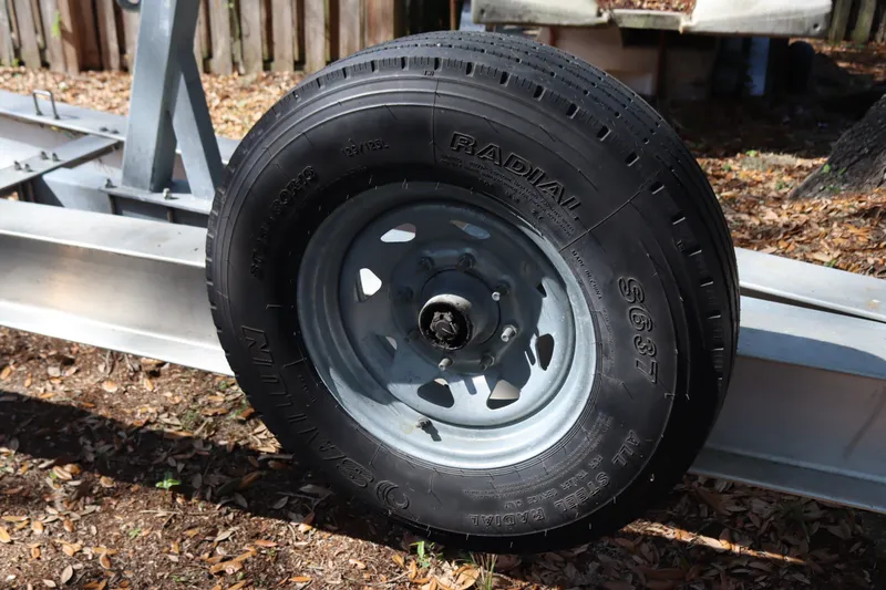 Slide: The Image of Trailer tire on a 2009 Hydra-Sports 4100 VSF boat trailer, parked outdoors. - 71