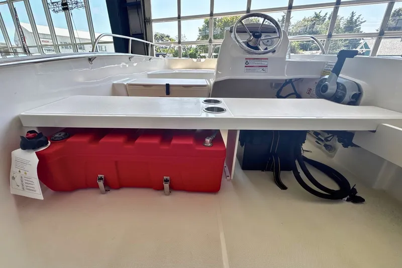 Slide: The Image of 2027 Boston Whaler 160 Super Sport interior with red fuel tank and steering console. - 6