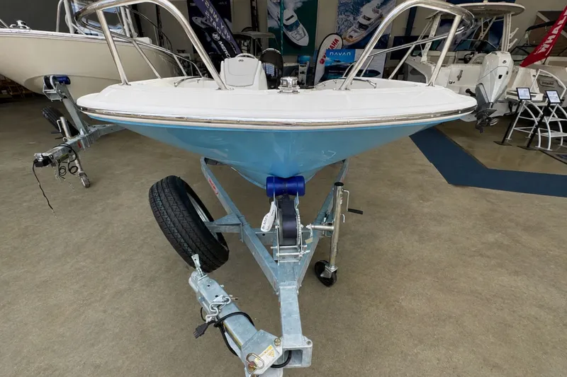 Slide: The Image of 2027 Boston Whaler 160 Super Sport boat on trailer in showroom. - 12