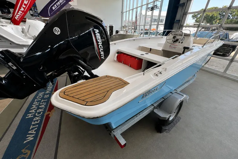Slide: The Image of 2027 Boston Whaler 160 Super Sport boat with Mercury engine in showroom. - 1