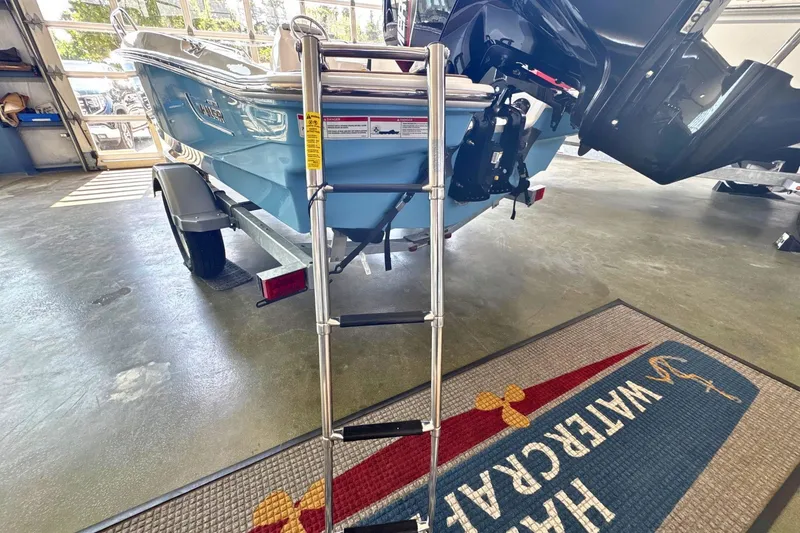 Slide: The Image of 2027 Boston Whaler 160 Super Sport boat on trailer with ladder in garage. - 4
