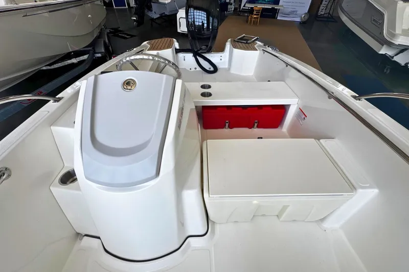 Slide: The Image of 2027 Boston Whaler 160 Super Sport boat interior with steering console and seating area. - 9