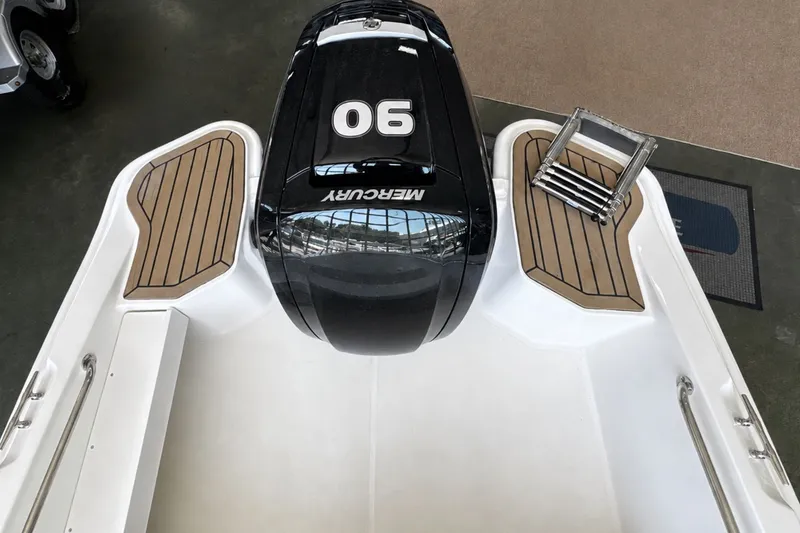 Slide: The Image of 2027 Boston Whaler 160 Super Sport boat with Mercury 90 engine, featuring teak-style decking. - 5