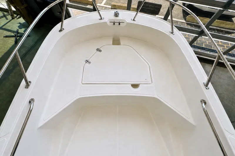 Slide: The Image of 2027 Boston Whaler 160 Super Sport boat interior with sleek white deck design. - 10