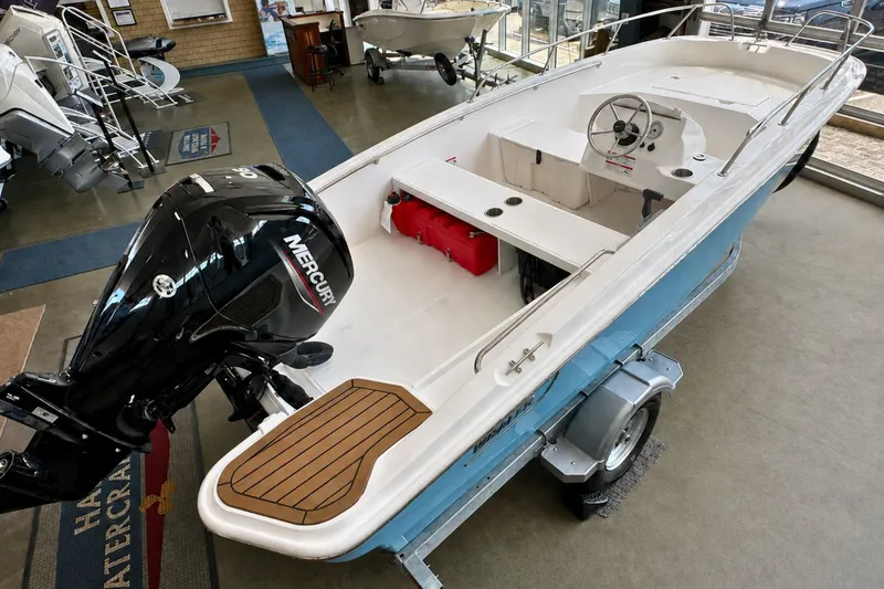 The Image of 2027 Boston Whaler 160 Super Sport boat with Mercury engine on display in showroom. - 0