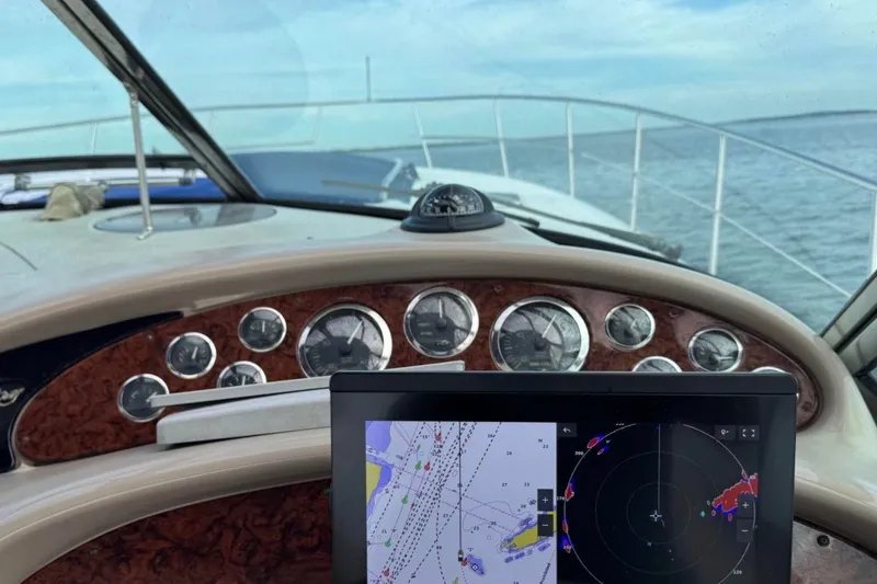 Slide: The Image of Cockpit view of 2000 Sea Ray 410 Sundancer with navigation display and gauges. - 8