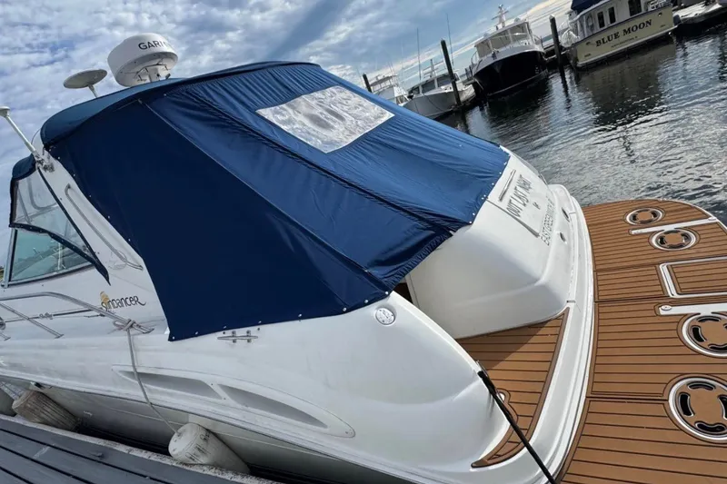 Slide: The Image of 2000 Sea Ray 410 Sundancer yacht docked with blue cover and wooden deck. - 6