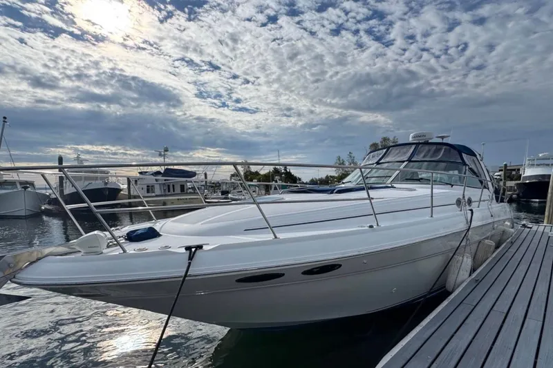 Slide: The Image of 2000 Sea Ray 410 Sundancer yacht docked under a cloudy sky. - 5