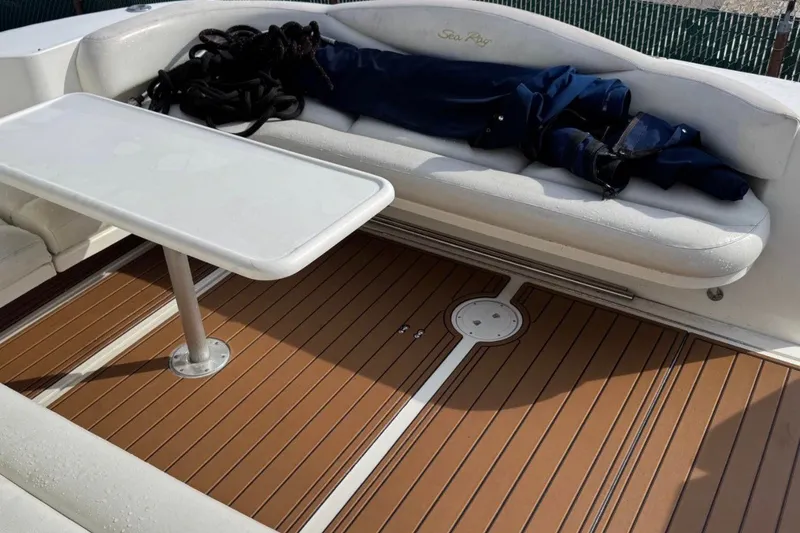 Slide: The Image of Interior of 2000 Sea Ray 410 Sundancer with white seating and wooden deck. - 2
