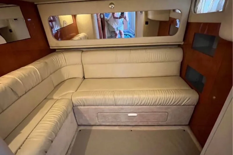 Slide: The Image of Interior of 2000 Sea Ray 410 Sundancer with beige seating and wood accents. - 3