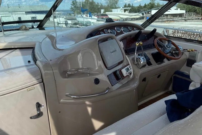 Slide: The Image of Cockpit of 2000 Sea Ray 410 Sundancer with steering wheel and navigation equipment. - 4