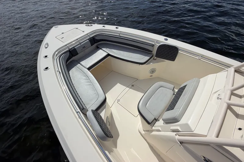 Slide: The Image of 2018 Cobia 301 Center Console boat with spacious seating, on calm water. - 6