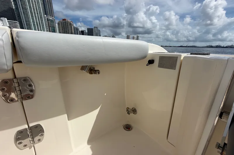Slide: The Image of 2018 Cobia 301 Center Console boat interior with city skyline and ocean view. - 41