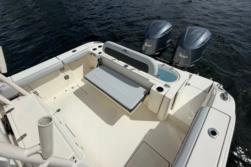 Slide: The Image of 2018 Cobia 301 Center Console boat with twin 300 engines on water. - 33