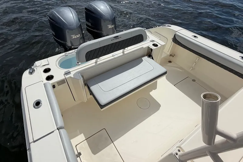 Slide: The Image of 2018 Cobia 301 Center Console boat with twin Yamaha 300 engines on water. - 34