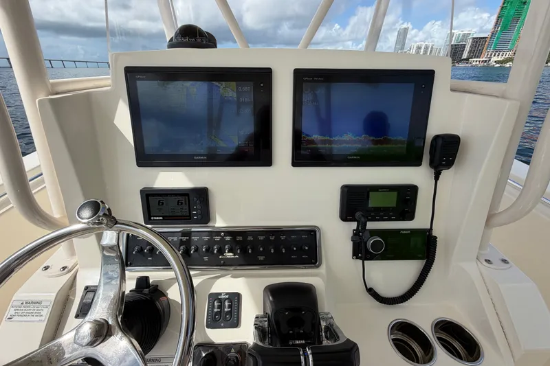 Slide: The Image of 2018 Cobia 301 Center Console helm with dual Garmin displays and controls. - 27