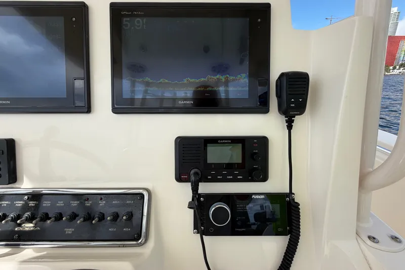Slide: The Image of Control panel of a 2018 Cobia 301 Center Console boat with Garmin displays. - 29