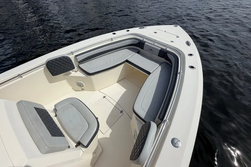 Slide: The Image of 2018 Cobia 301 Center Console boat with spacious seating on calm water. - 9