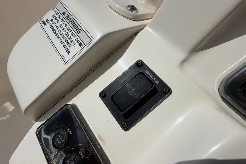 Slide: The Image of 2018 Cobia 301 Center Console windlass switch and warning label detail. - 32