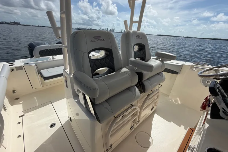 Slide: The Image of 2018 Cobia 301 Center Console boat interior with dual seats, ocean view. - 24