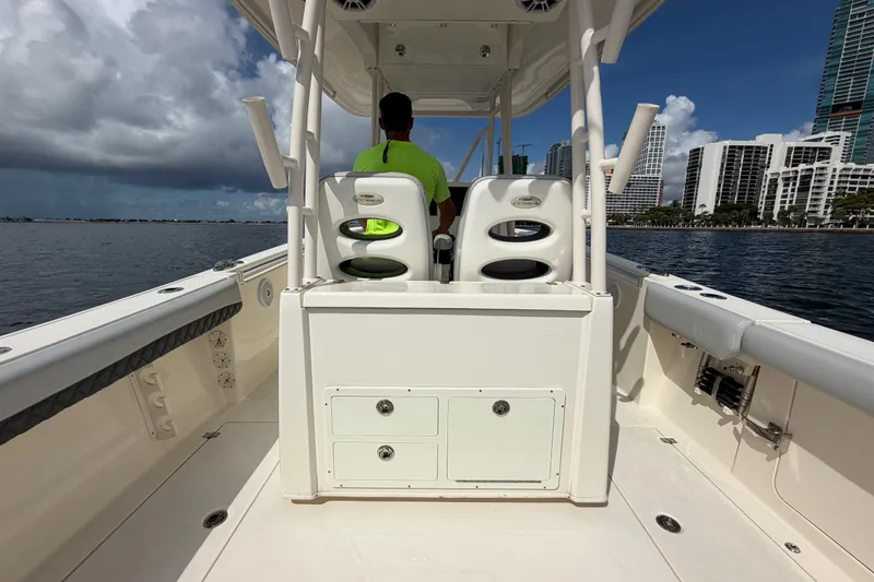 Slide: The Image of 2018 Cobia 301 Center Console boat on water, city skyline in background. - 39