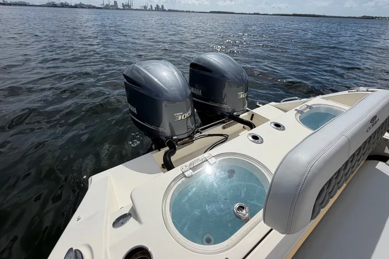 Slide: The Image of 2018 Cobia 301 Center Console boat with twin Yamaha 300 engines on open water. - 35