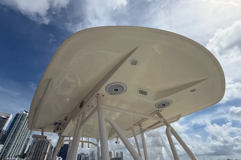 Slide: The Image of 2018 Cobia 301 Center Console boat top view against a cloudy sky. - 19
