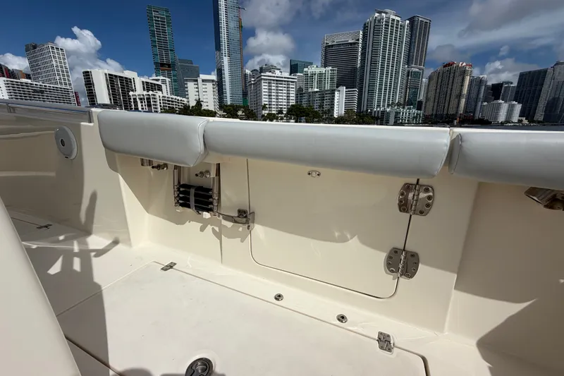 Slide: The Image of 2018 Cobia 301 Center Console boat interior with city skyline in the background. - 40