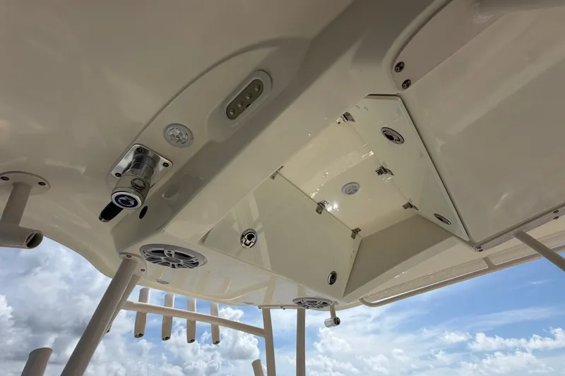 Slide: The Image of 2018 Cobia 301 Center Console boat's overhead view with speakers and rod holders. - 25