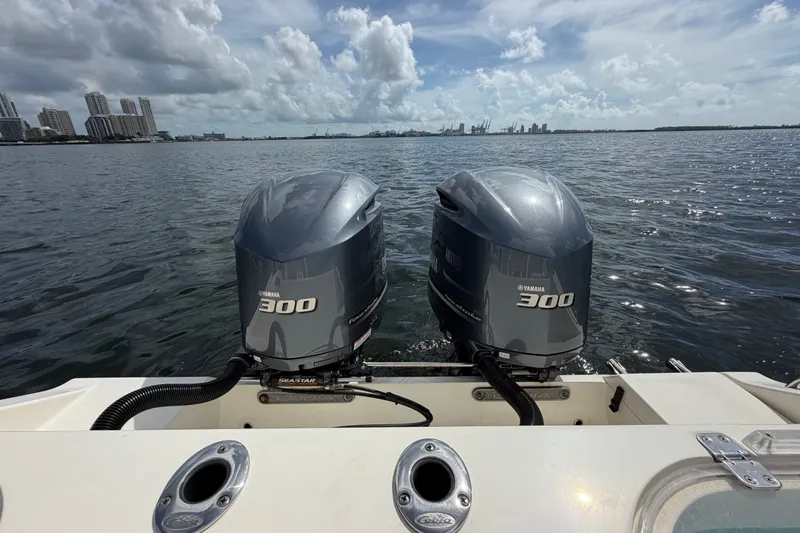 Slide: The Image of 2018 Cobia 301 Center Console with twin Yamaha 300 engines on open water. - 36