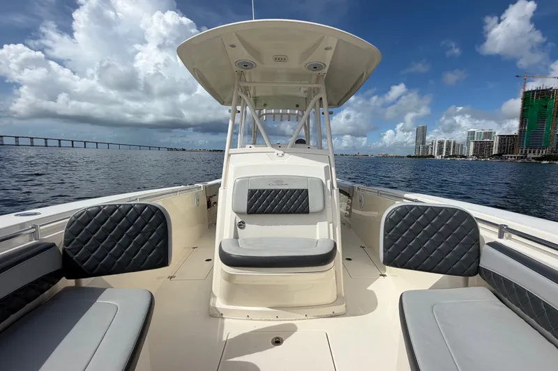 Slide: The Image of 2018 Cobia 301 Center Console boat on water, city skyline in background. - 14