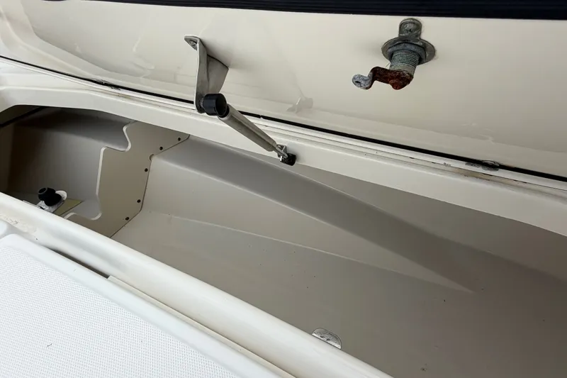 Slide: The Image of Open storage compartment of a 2006 Boston Whaler 270 Outrage boat. - 44