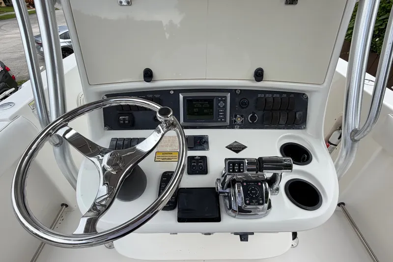 Slide: The Image of 2006 Boston Whaler 270 Outrage helm with steering wheel and control panel. - 19