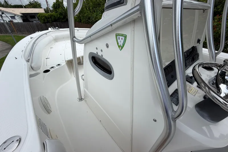Slide: The Image of 2006 Boston Whaler 270 Outrage boat interior with steering console and safety check sticker. - 29