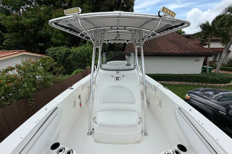 Slide: The Image of 2006 Boston Whaler 270 Outrage boat with T-top and seating, parked outdoors. - 40