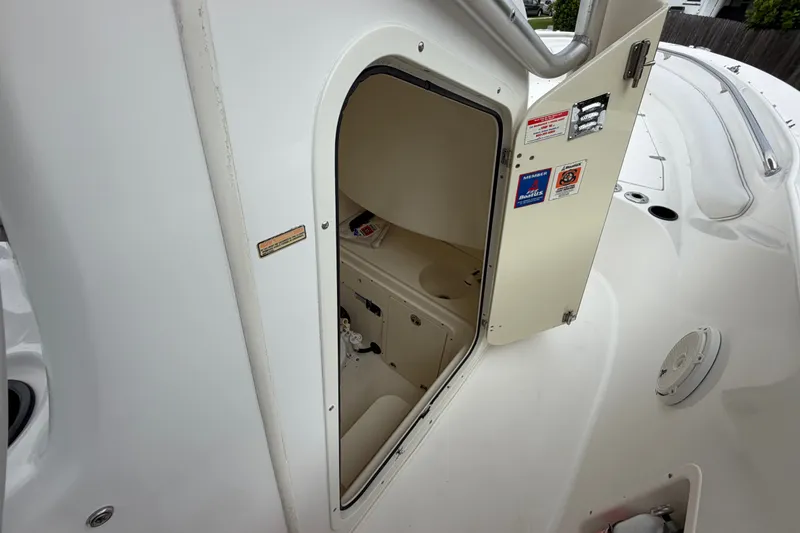 Slide: The Image of Open storage compartment on a 2006 Boston Whaler 270 Outrage boat deck. - 30
