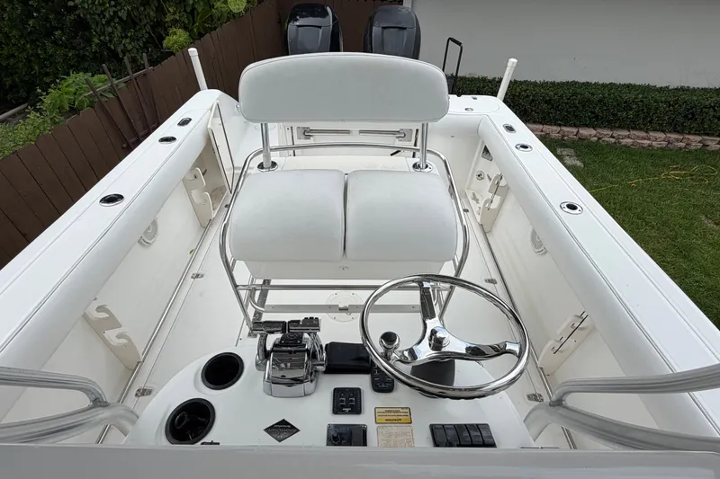 Slide: The Image of 2006 Boston Whaler 270 Outrage boat cockpit with steering wheel and seating. - 27