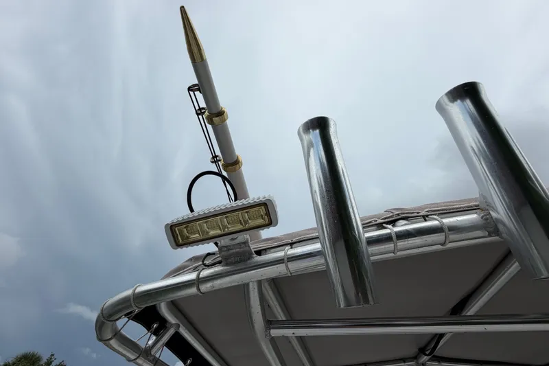 Slide: The Image of Boston Whaler 270 Outrage 2006 boat with rod holders and antenna against cloudy sky. - 15