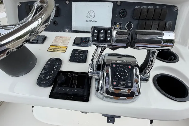 Slide: The Image of Control panel of a 2006 Boston Whaler 270 Outrage boat with steering and throttle controls. - 17