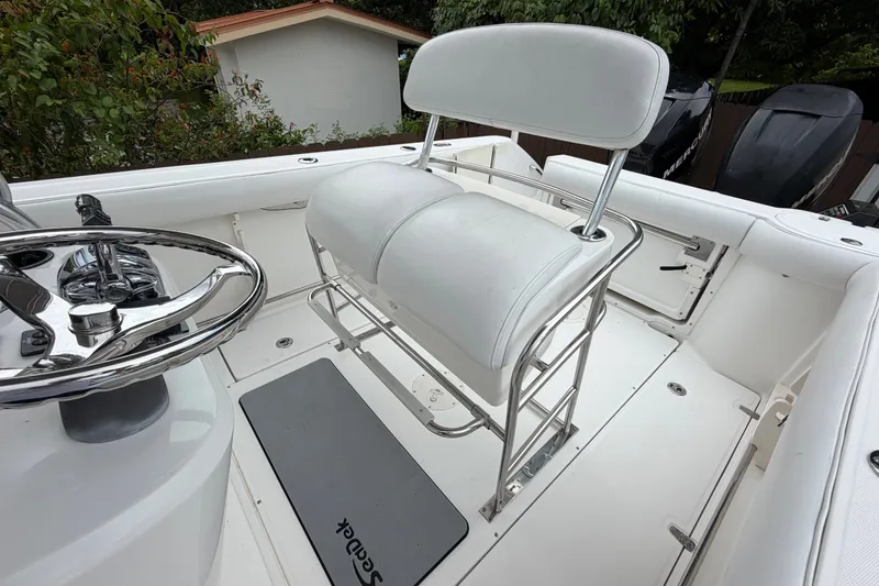 Slide: The Image of 2006 Boston Whaler 270 Outrage helm seat and steering wheel, showcasing sleek design. - 28