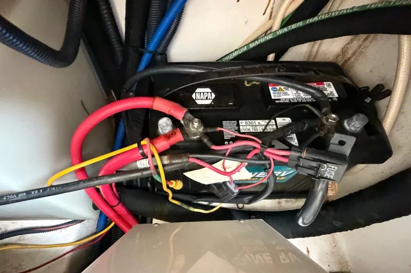 Slide: The Image of Battery setup in a 2006 Boston Whaler 270 Outrage boat, featuring wiring and fuse connections. - 47