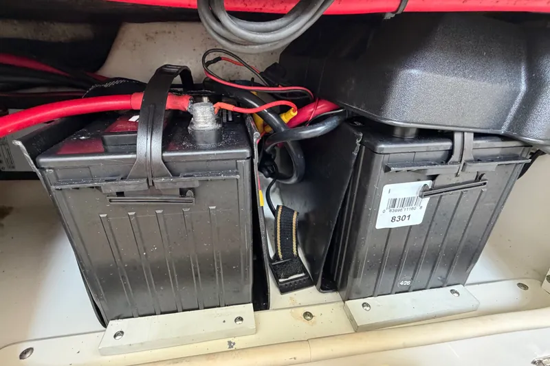Slide: The Image of Batteries in a 2006 Boston Whaler 270 Outrage boat, secured with straps and connected by cables. - 45