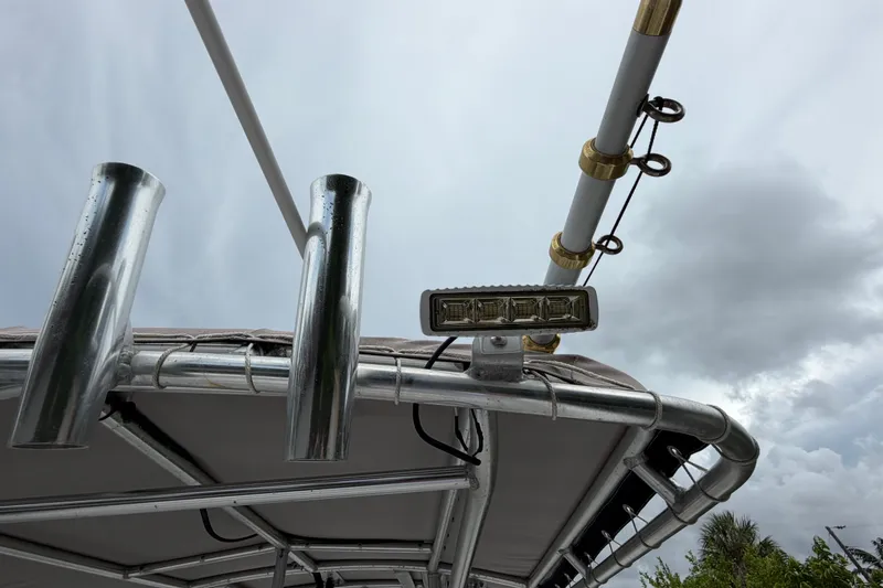 Slide: The Image of Boston Whaler 270 Outrage 2006 boat with metal fixtures and cloudy sky background. - 14