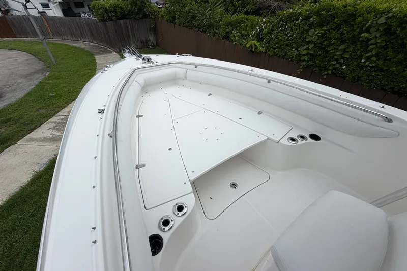Slide: The Image of 2006 Boston Whaler 270 Outrage boat deck, featuring spacious seating and storage compartments. - 34