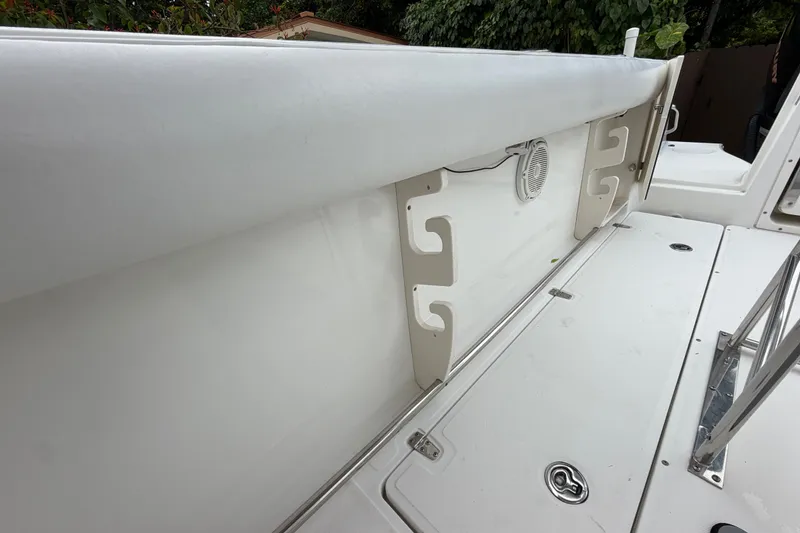 Slide: The Image of 2006 Boston Whaler 270 Outrage boat interior with rod holders and speaker. - 24