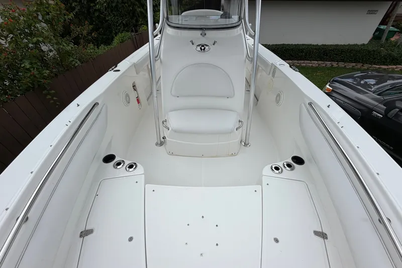 Slide: The Image of 2006 Boston Whaler 270 Outrage boat interior, featuring spacious seating and stainless steel fixtures. - 39